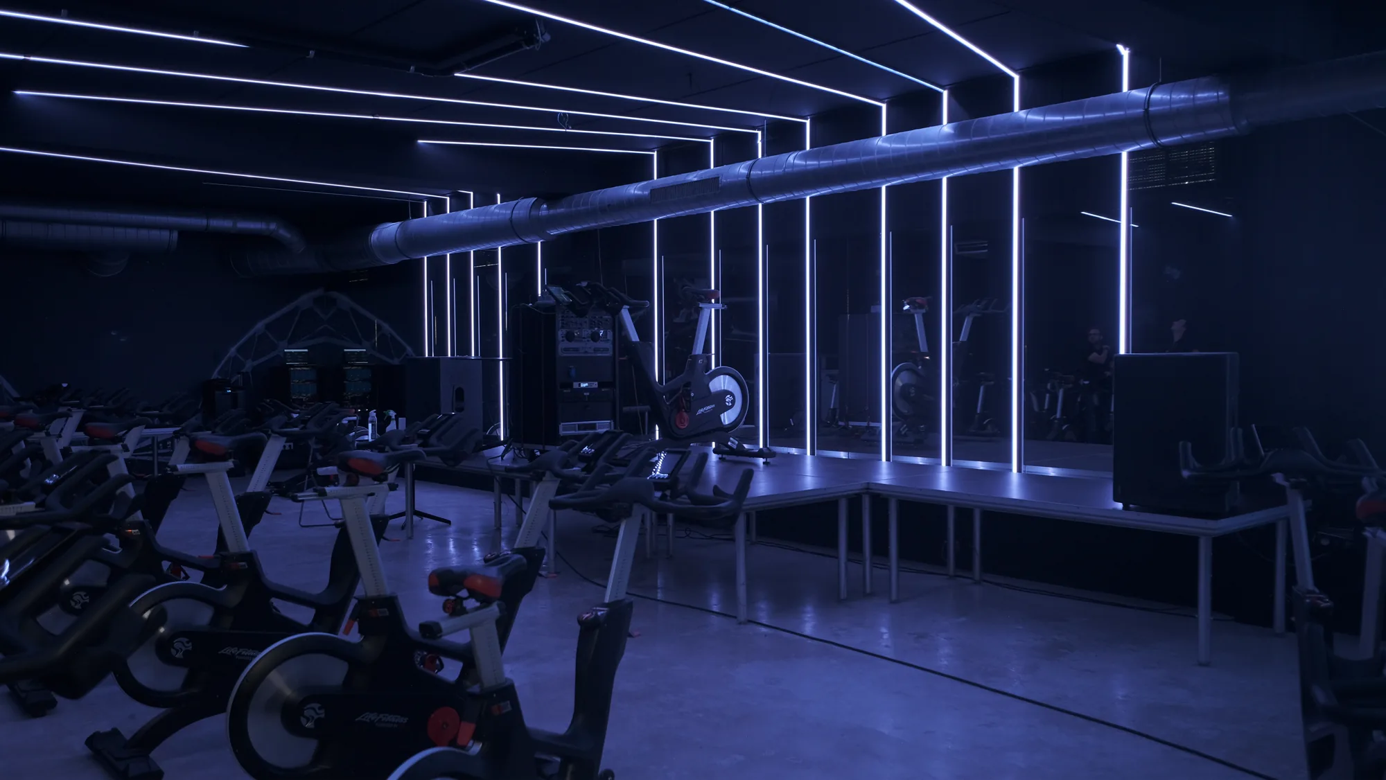 Olympia Hasselt spinning room with white LED lines above the bikes