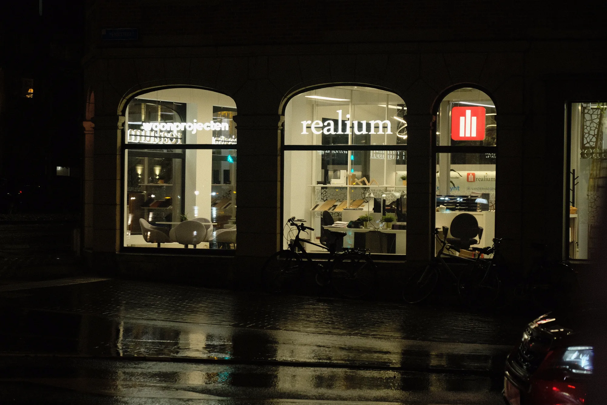 Realium illuminated letters in the Tiensepoort windows at night