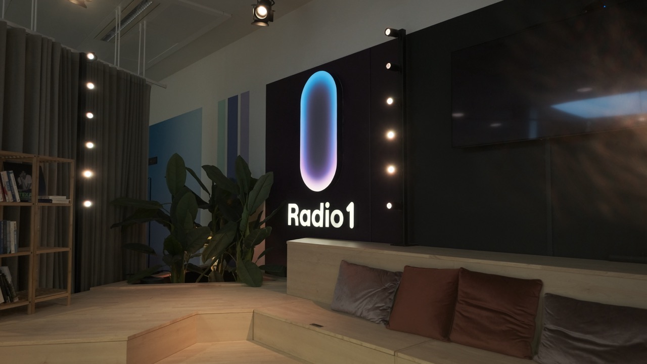 New Radio 1 logo as a gradient light box above the lounge