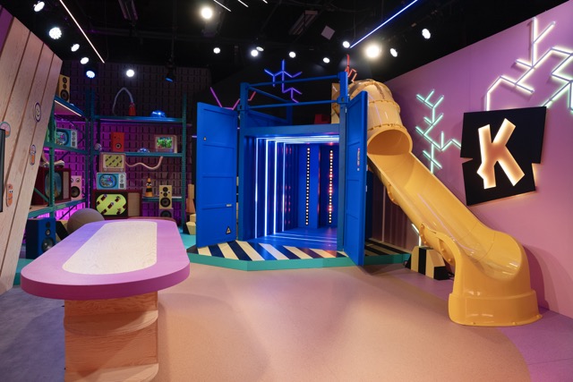 Ketnet studio with lit container, slide and K logo