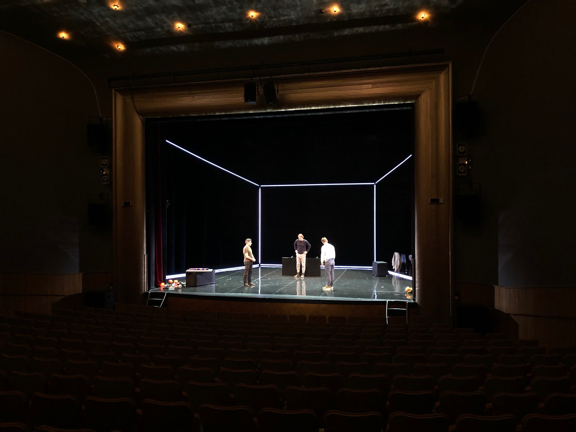 The play ART on a minimalist set outlined with LED strips