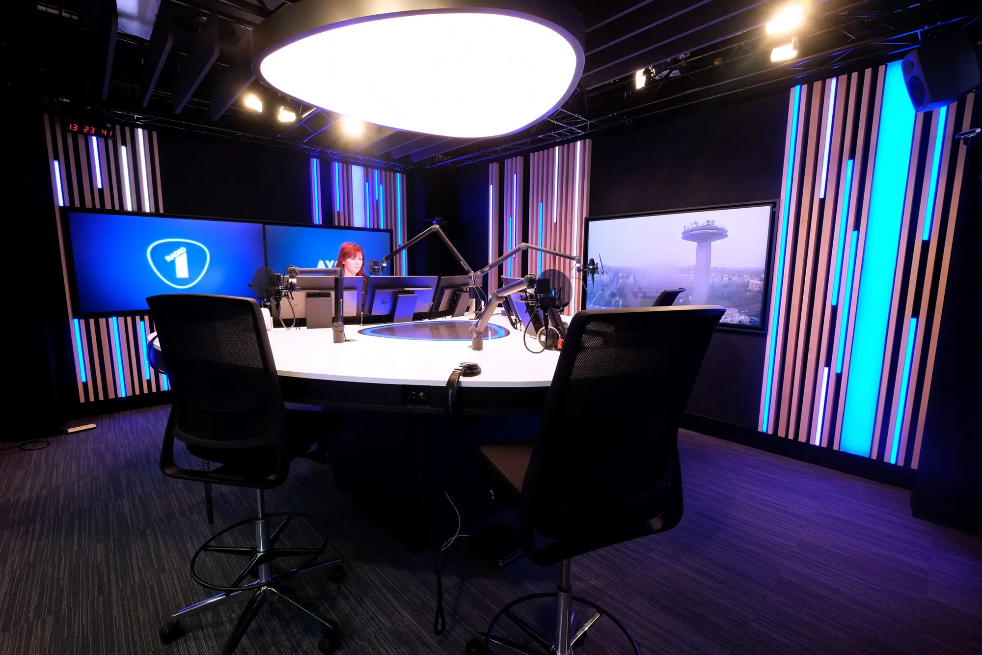 VRT Radio 1 studio with vertical LED strips and a round ceiling fixture