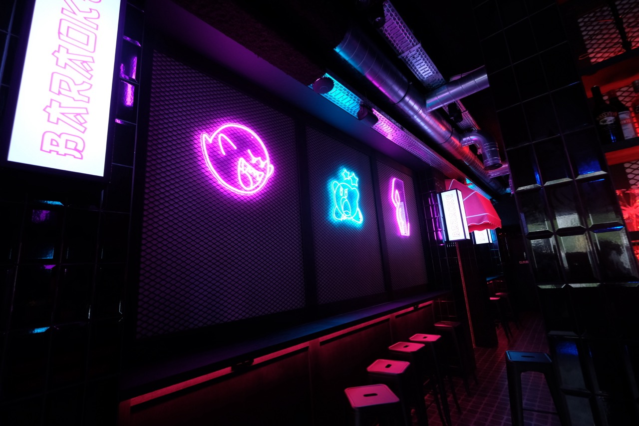 Pink and blue neon signs in the Baraoke karaoke bar in Ghent